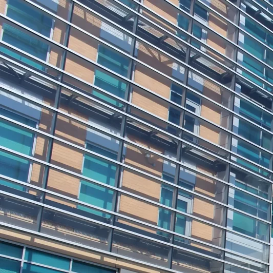 A close up of the orange and green double-skin facade of the California Department of Motor Vehicles HQ in Sacramento CA.