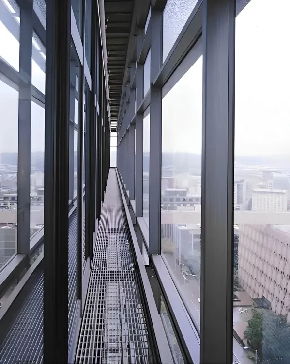 Inside the cavity of the double-skin facade of the Seattle Justice Center showing the interstitial walkways and steel & glass construction.