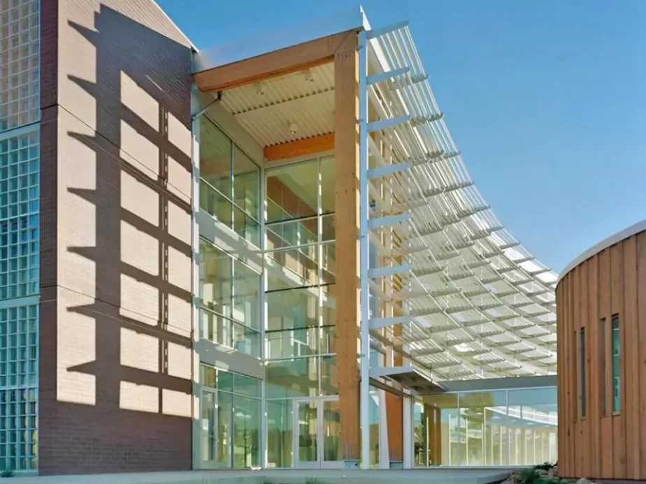The curved shading devices of the Applied R&D Building at Northern Arizona University, set against a bright blue sky.