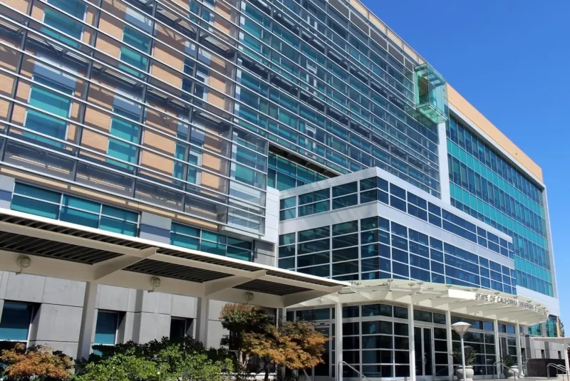 The shading system on the green glass and orange brick facade of the CA DMV HQ in Sacramento, CA.