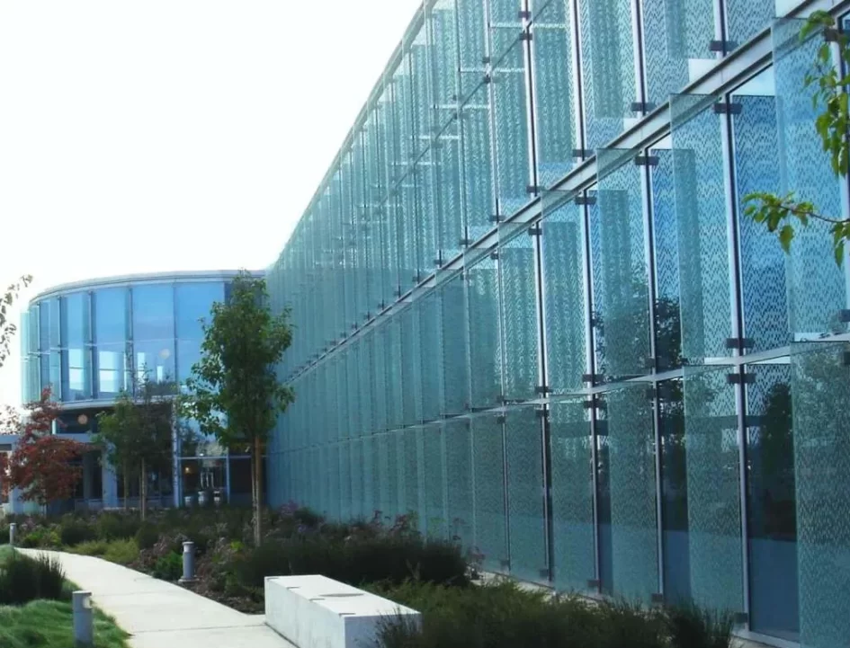 The blue green fritted glass vertical shades on the facade of Valley Health Center in Gilroy.