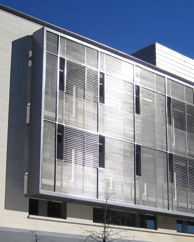 The dark gray, metal shading system set against the light gray facade of the Goel Quantum Science & Engineering Building at Harvard University.
