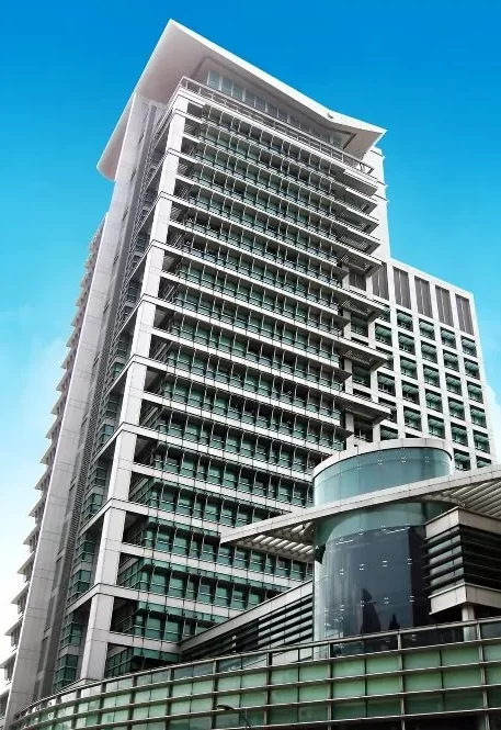 The pale concrete & glass facade of the Ministry of Education HQ high-rise building in Singapore.