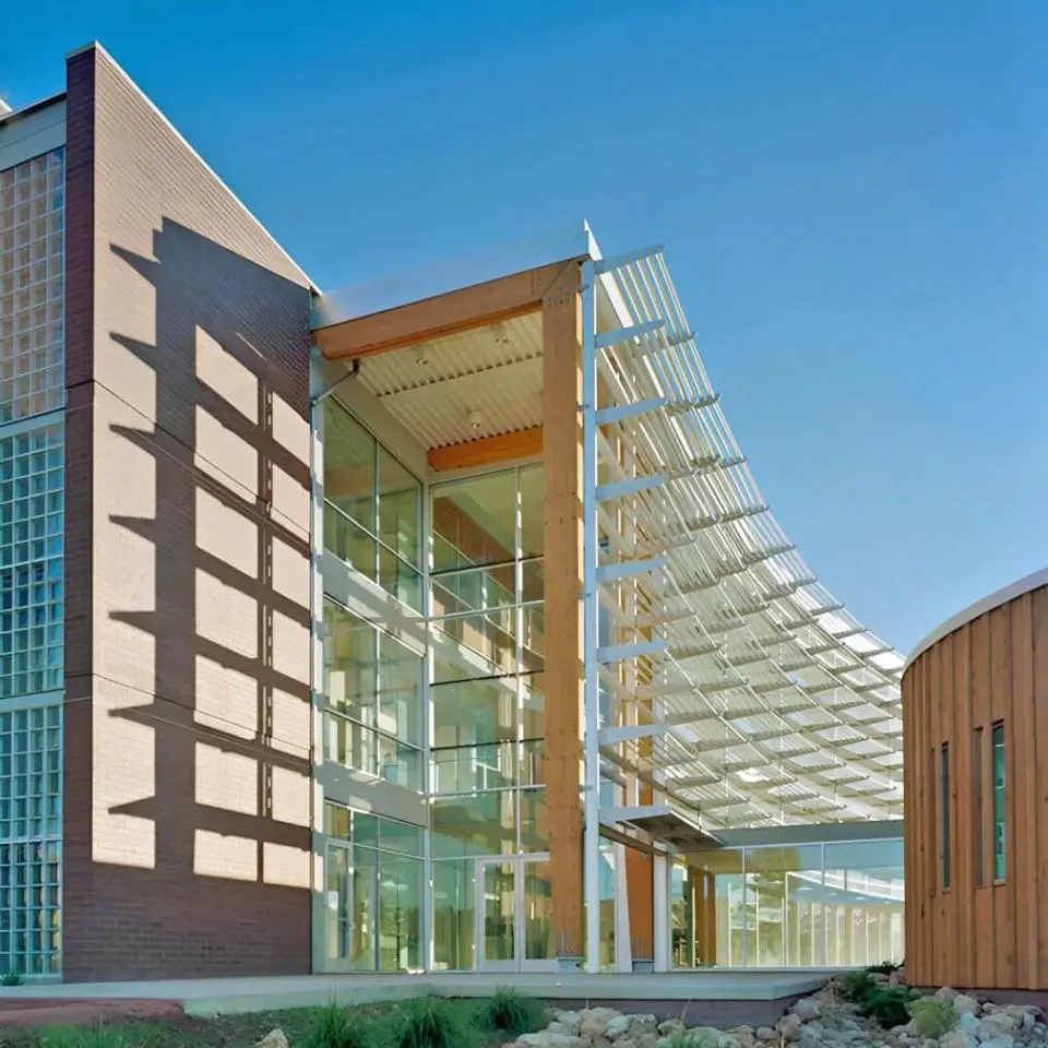 The curved shading devices of the Applied R&D Building at Northern Arizona University, set against a bright blue sky.