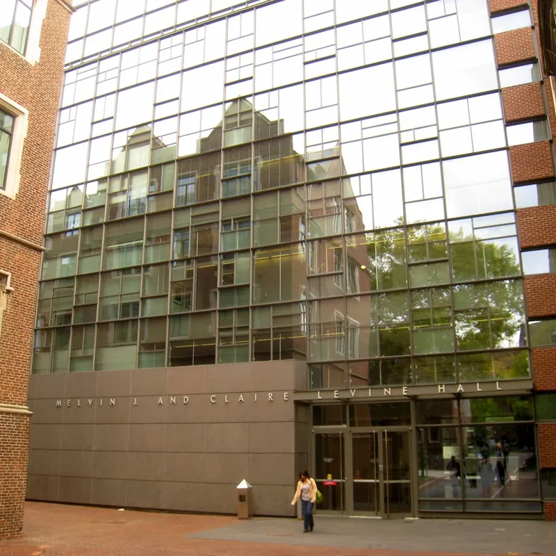 The highly reflective steel and glass front facade of Levine Hall at the University of Pennsylvania.