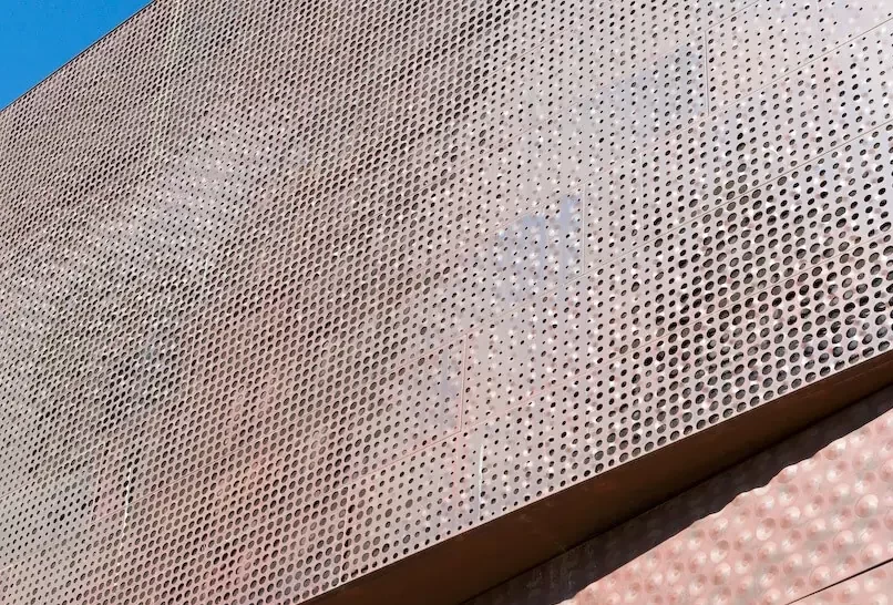 Close-up view of the perforated brown steel facade of the de Young Museum.