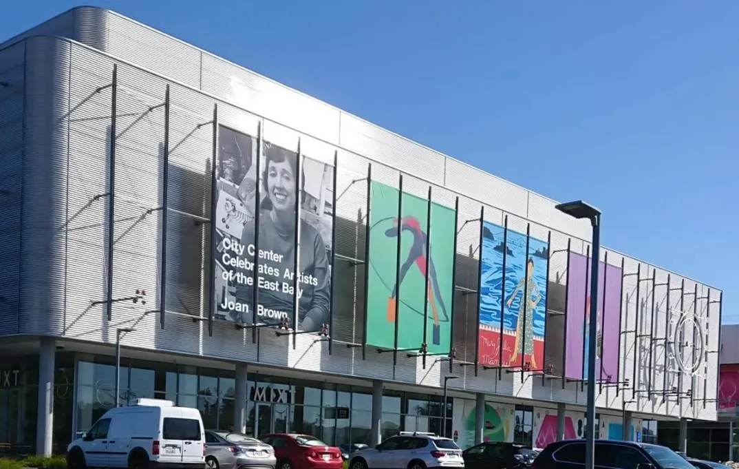 The corrugated silver stainless steel facade and brightly colored surface posters of City Center Bishop Ranch in San Ramon, CA.