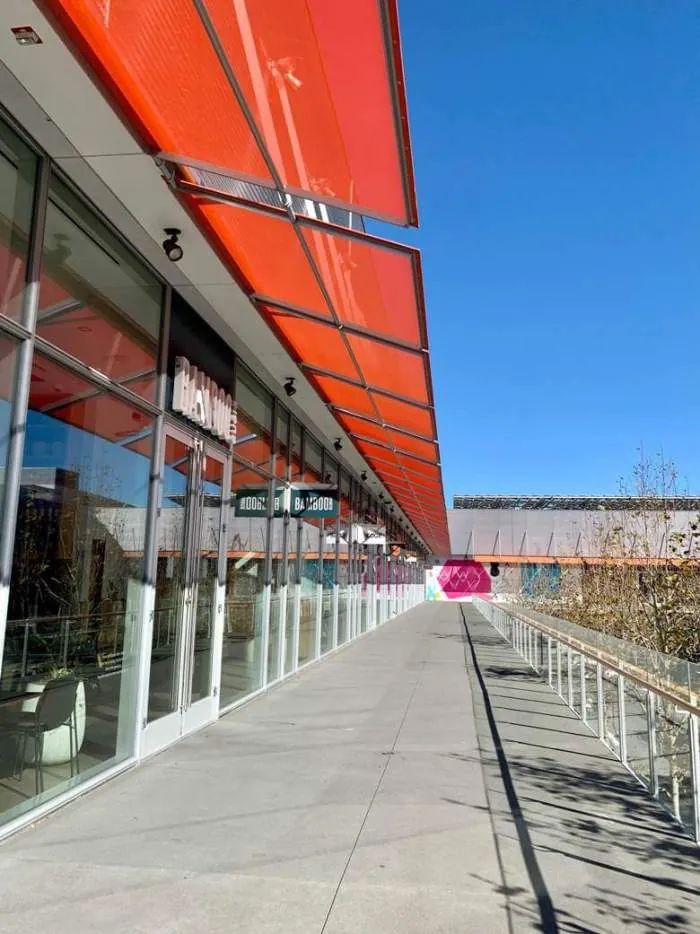 Red fabric canopies shading the glass storefront of City Center Bishop Ranch in San Ramon, CA.