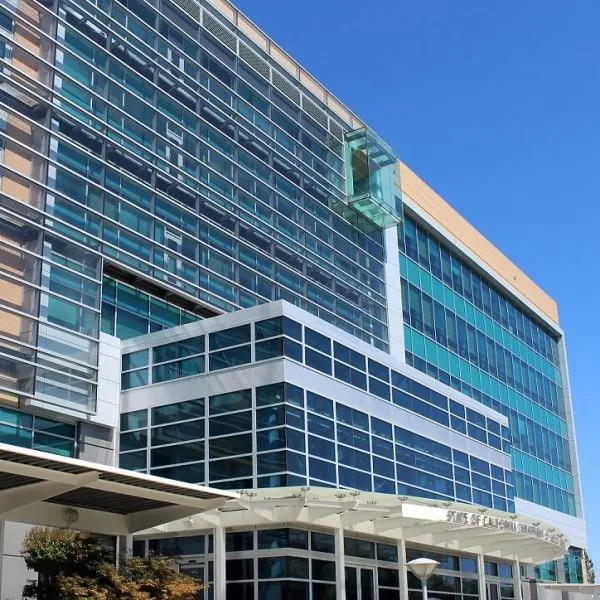 The shading system on the green glass and orange brick facade of the CA DMV HQ in Sacramento, CA.